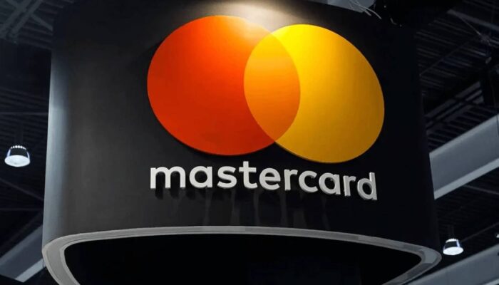 Mastercard and Solana logos connected by AI and blockchain payment network visuals representing intelligent digital transactions