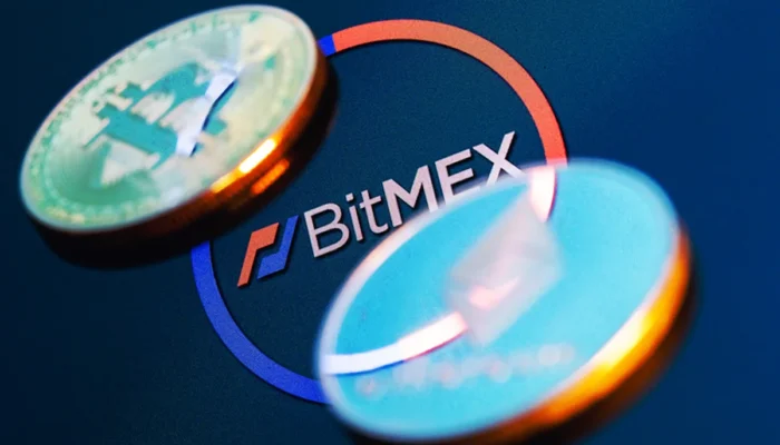 The BitMEX logo displayed with a closing notification, cryptocurrency trading charts, and digital asset symbols, representing the exchange's shutdown after 11 years.