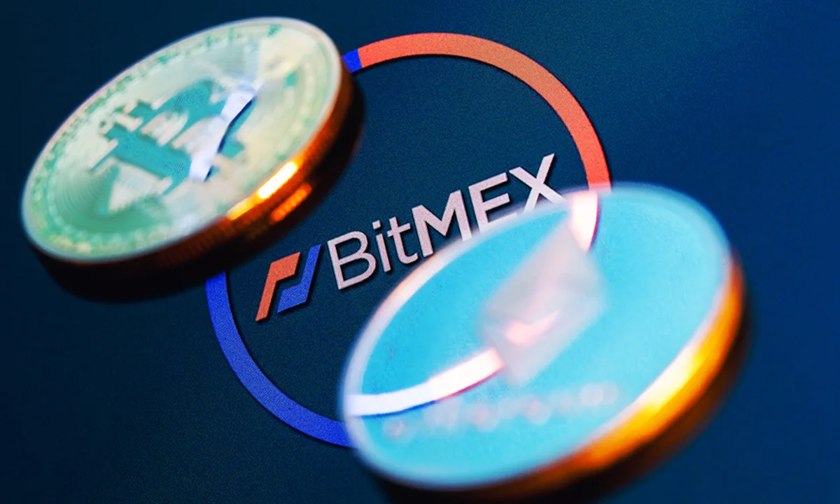 The BitMEX logo displayed with a closing notification, cryptocurrency trading charts, and digital asset symbols, representing the exchange's shutdown after 11 years.