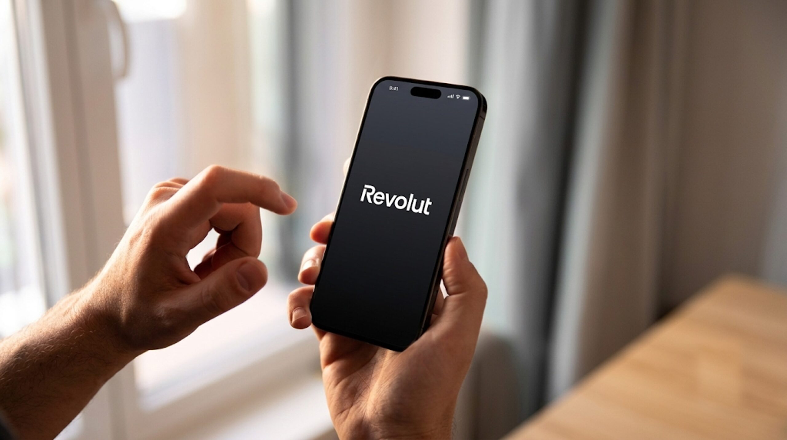 Revolut A smartphone displaying the Revolut app alongside Bitcoin and Ethereum symbols with the UAE skyline in the background, representing the company's plans to launch crypto services in the Emirates.