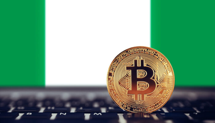 A smartphone displaying a cryptocurrency trading app alongside a Nigerian Tax Identification Number (TIN) document, illustrating Nigeria's new tax rule for crypto accounts.
